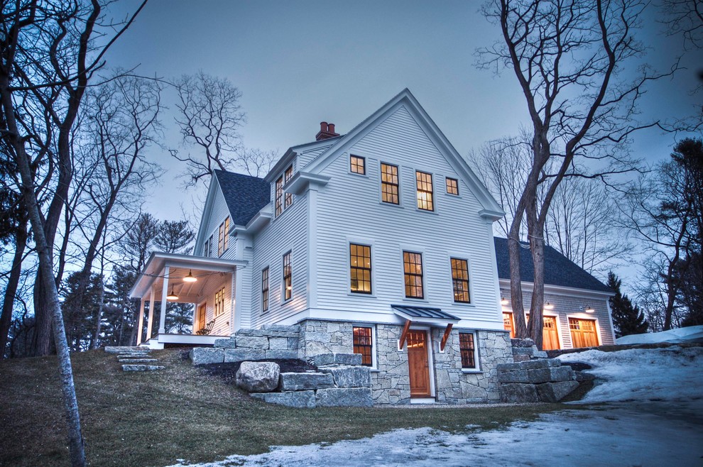 Photo of a classic house exterior in Portland Maine with stone cladding and a shingle roof.