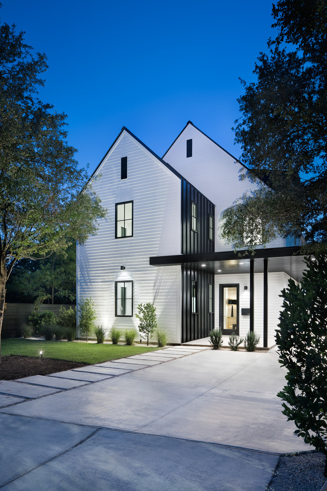 Large farmhouse white two-story wood exterior home idea in Austin with a mixed material roof