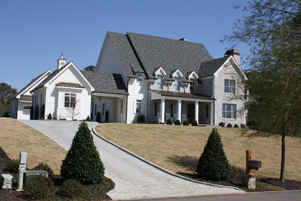Large farmhouse multicolored two-story mixed siding exterior home photo in Atlanta with a shingle roof