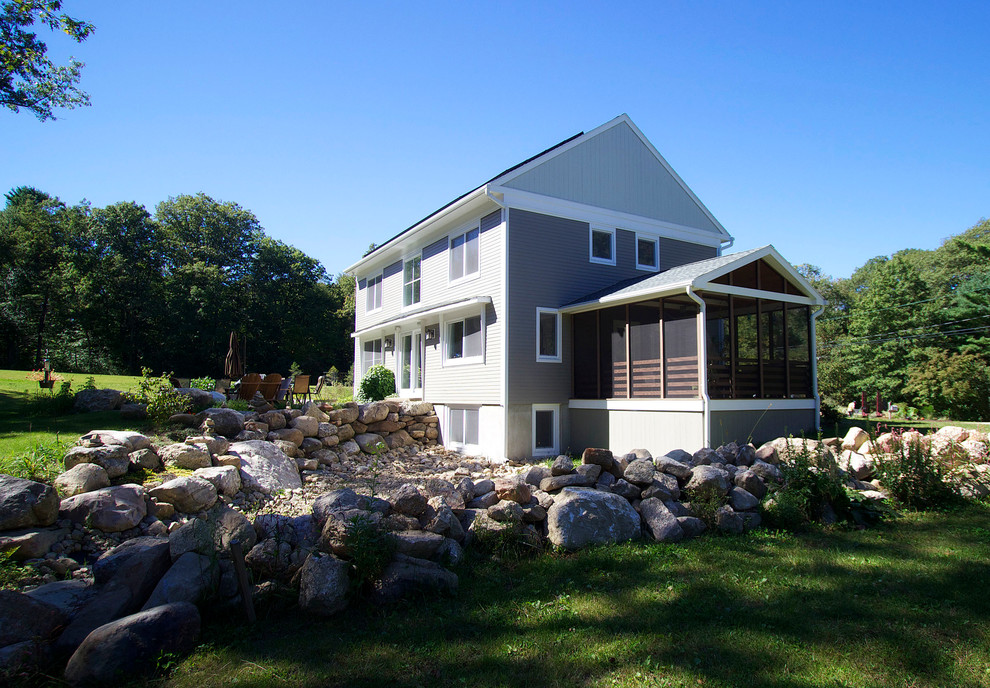 Example of a mid-sized cottage gray two-story concrete fiberboard gable roof design in Bridgeport