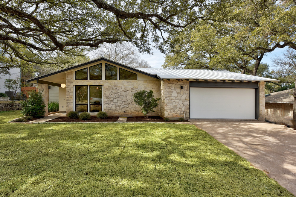 Mid-century modern beige one-story stone exterior home idea in Austin with a mixed material roof