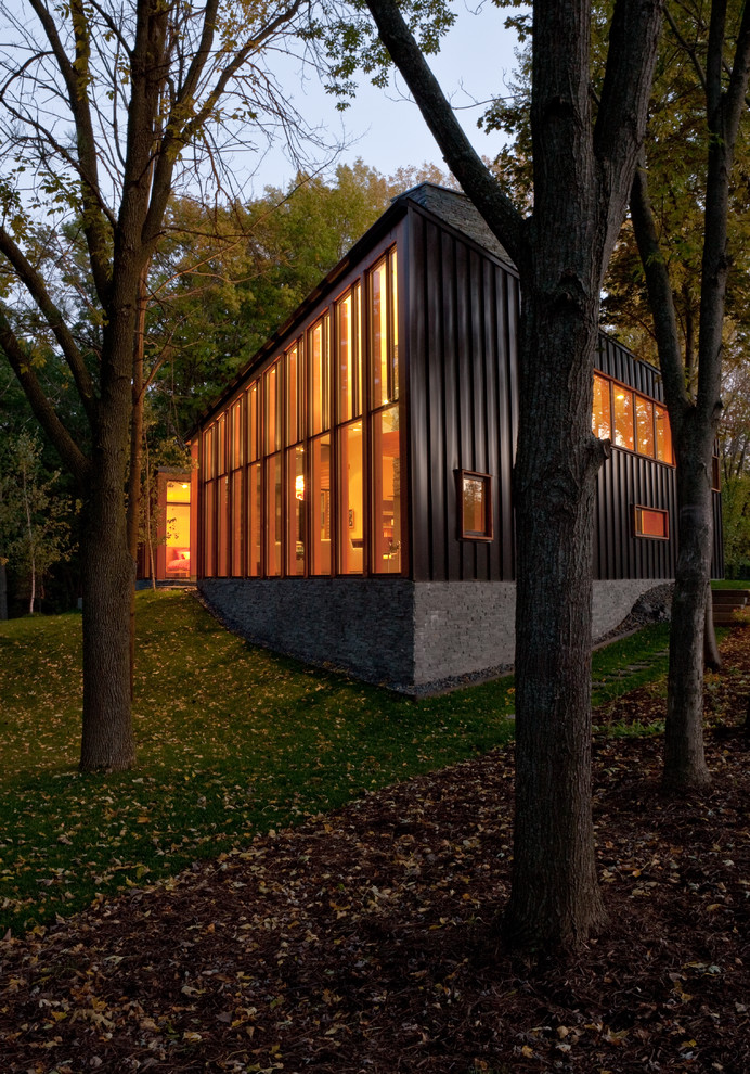 Design ideas for a contemporary house exterior in Minneapolis with metal cladding.