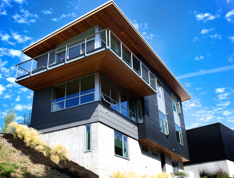 Design ideas for a black contemporary two floor house exterior in Seattle with wood cladding.