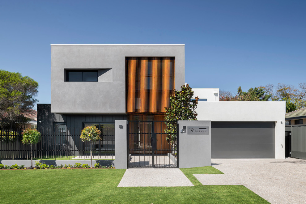 Imagen de fachada de casa multicolor contemporánea de tamaño medio de dos plantas con revestimientos combinados y tejado plano