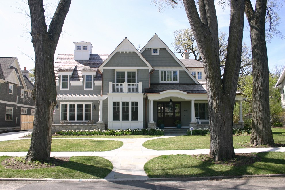 Example of an ornate two-story wood exterior home design in Chicago