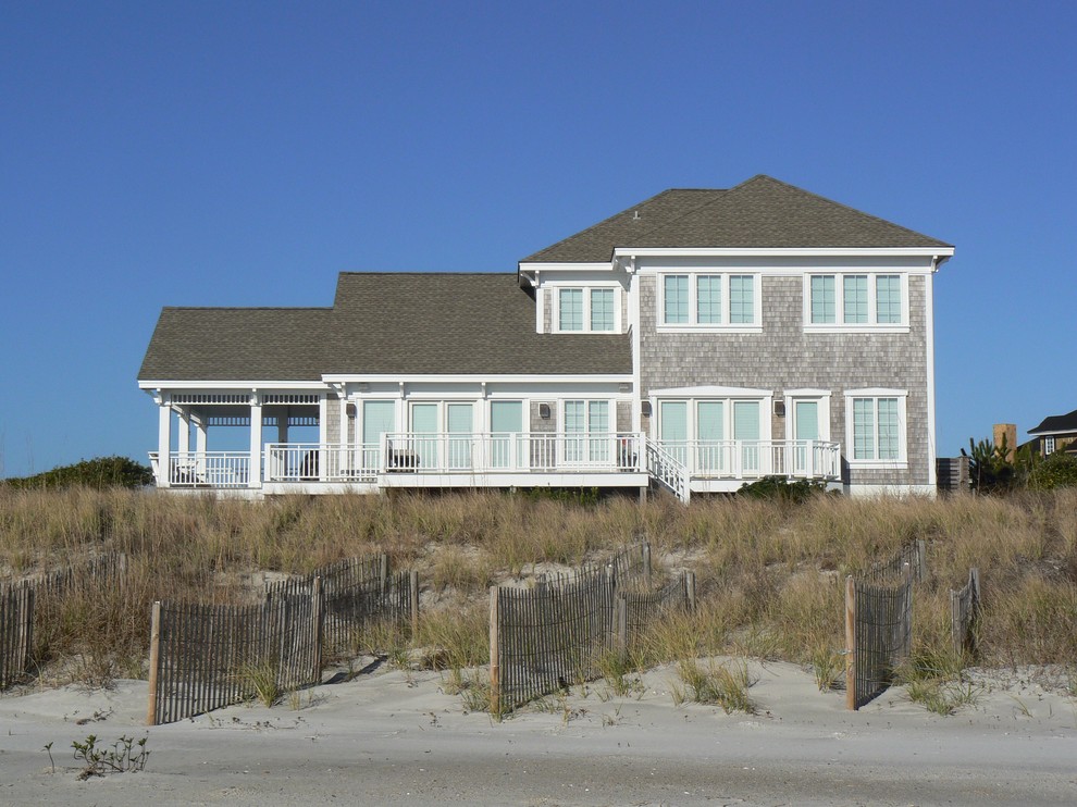 Example of a mid-sized beach style gray three-story wood gable roof design in Wilmington