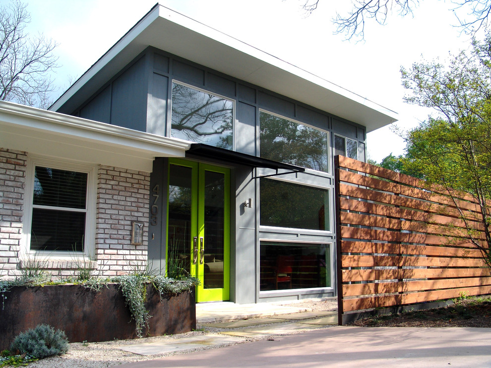 Design ideas for a contemporary brick house exterior in Austin.