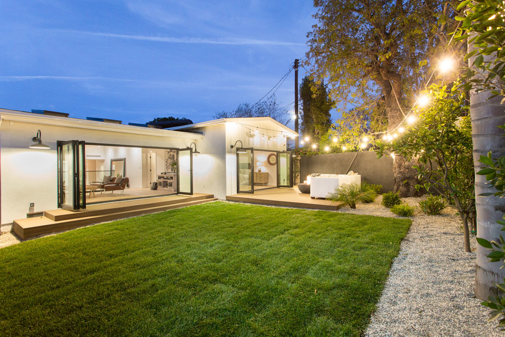 Mid-sized cottage white one-story concrete fiberboard house exterior idea in Los Angeles with a hip roof and a shingle roof