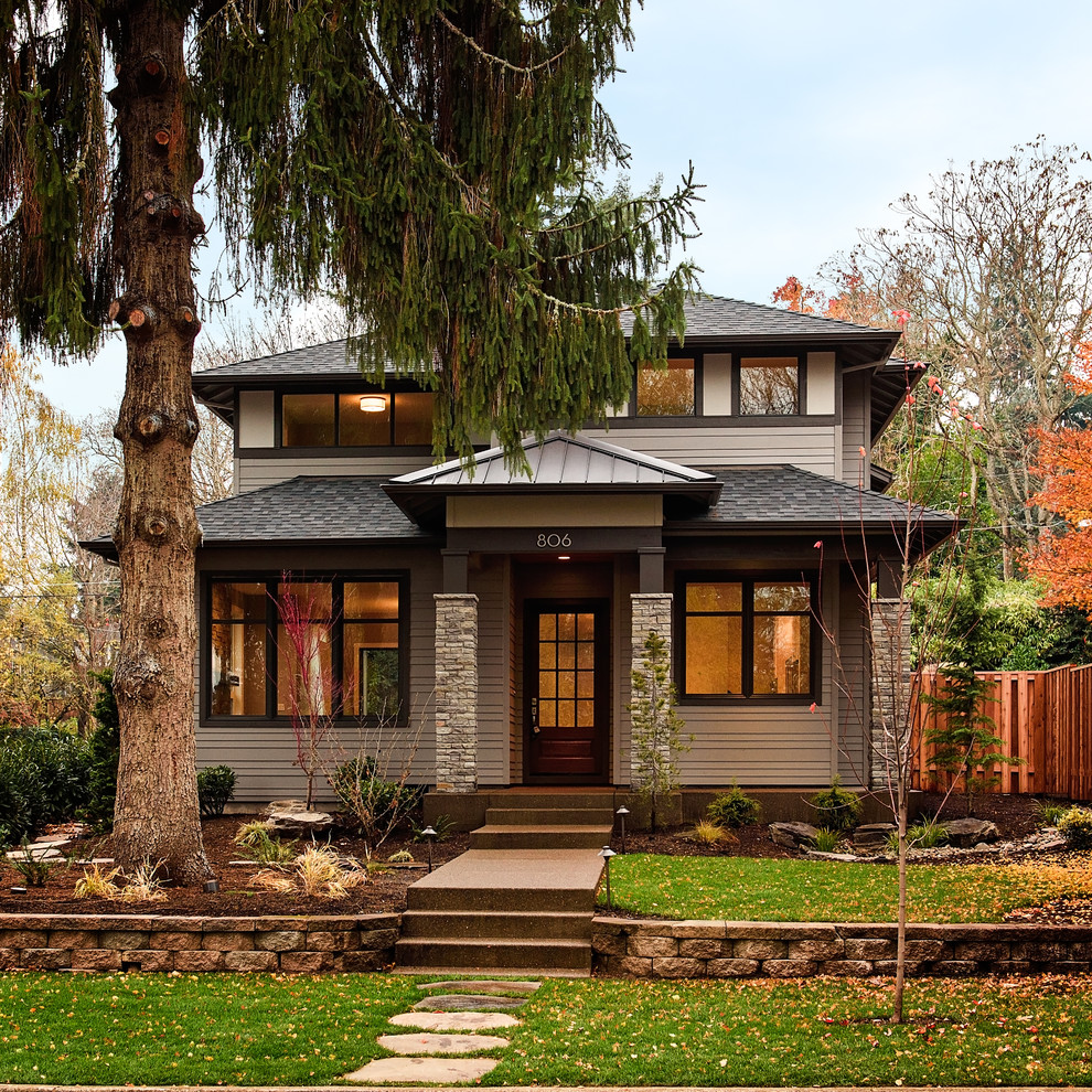Beige traditional two floor house exterior in Portland with a hip roof.