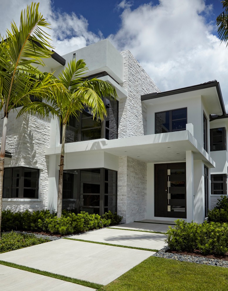 Example of a mid-sized trendy exterior home design in Miami