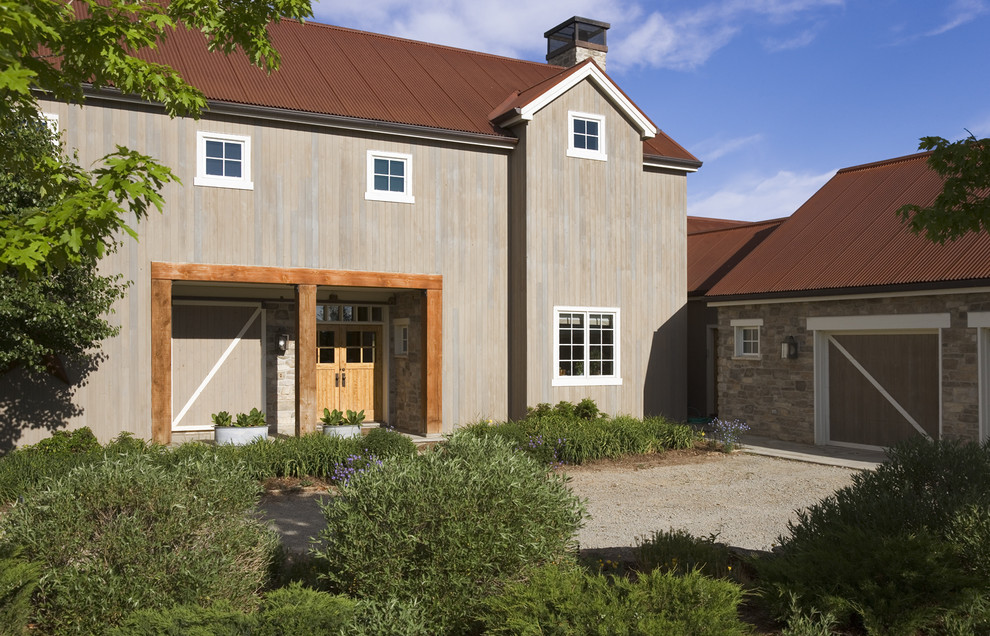 This is an example of a rural two floor house exterior in Denver with wood cladding.