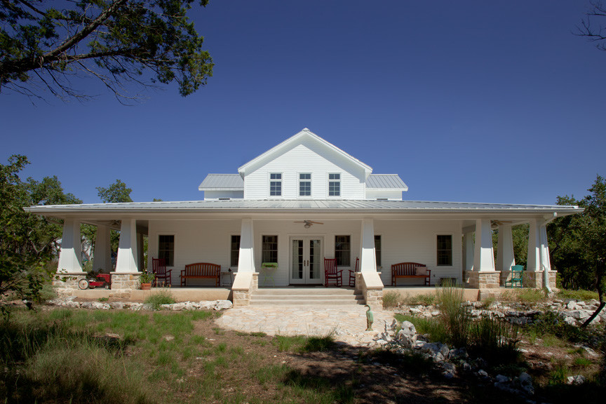 Example of a large farmhouse white two-story wood exterior home design in Austin