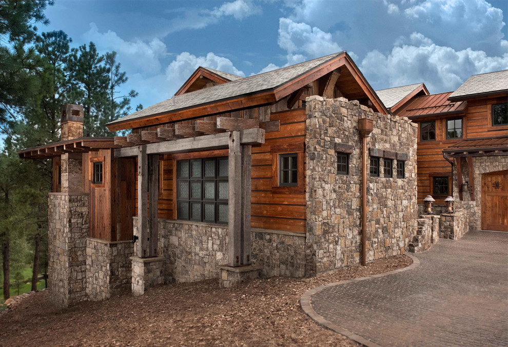 Large rustic two floor house exterior in Phoenix with stone cladding.
