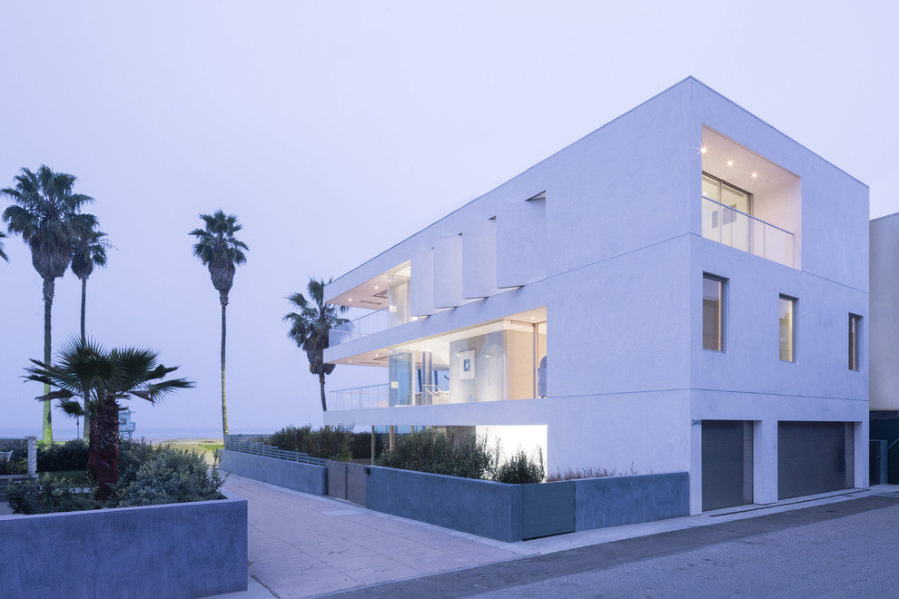 Photo of a large and white modern render house exterior in Los Angeles with three floors.