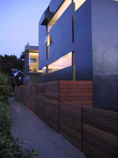 Mid-sized modern black two-story stucco exterior home idea in Los Angeles with a mixed material roof