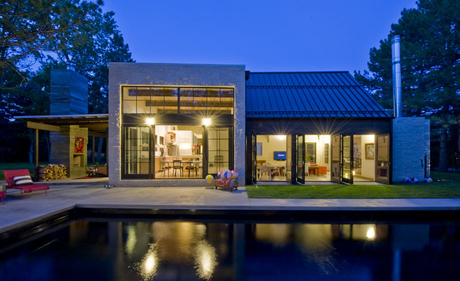 This is an example of a large and gey contemporary house exterior in Denver with a pitched roof.