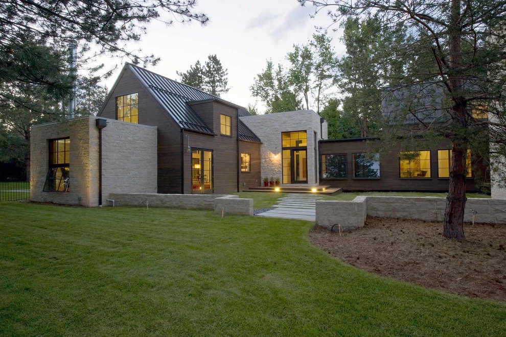 This is an example of a country two floor house exterior in Denver with mixed cladding and a pitched roof.