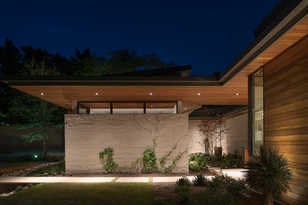 Large contemporary two-story wood house exterior idea in Austin with a metal roof