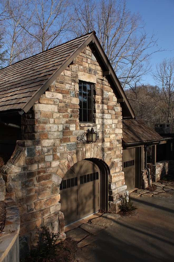 Large traditional multicolored one-story stone gable roof idea in Other