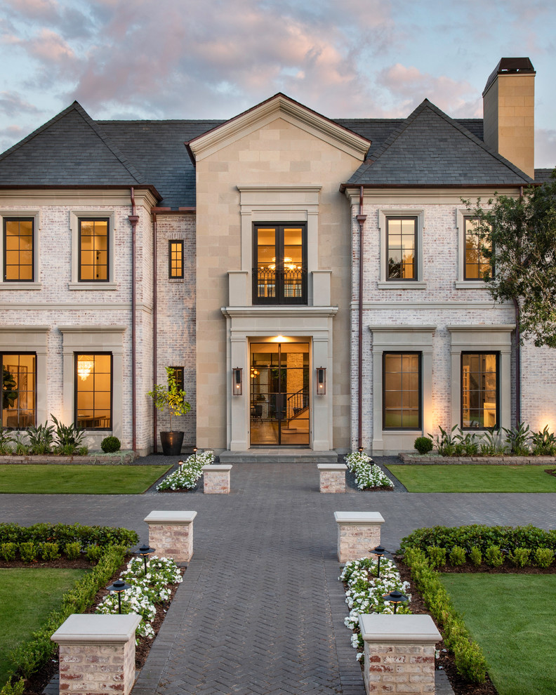 Inspiration for a huge transitional two-story brick exterior home remodel in Houston with a tile roof