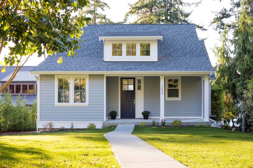 Mid-sized farmhouse multicolored two-story wood exterior home photo in Seattle with a shingle roof