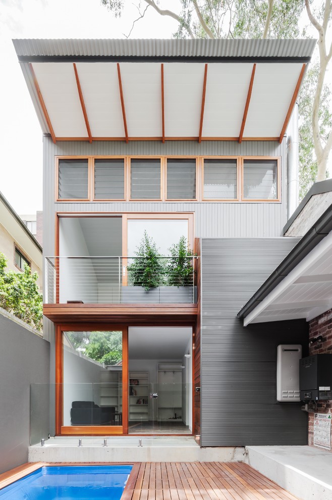 Gey contemporary two floor house exterior in Sydney with a lean-to roof.
