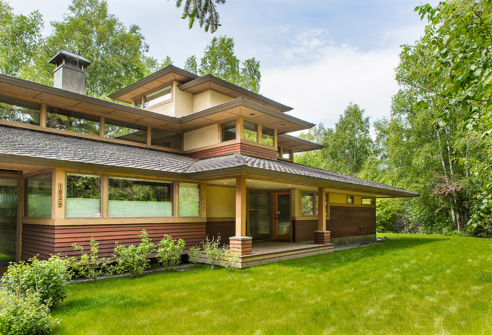 Inspiration for a large contemporary brown three-story wood exterior home remodel in Other with a tile roof