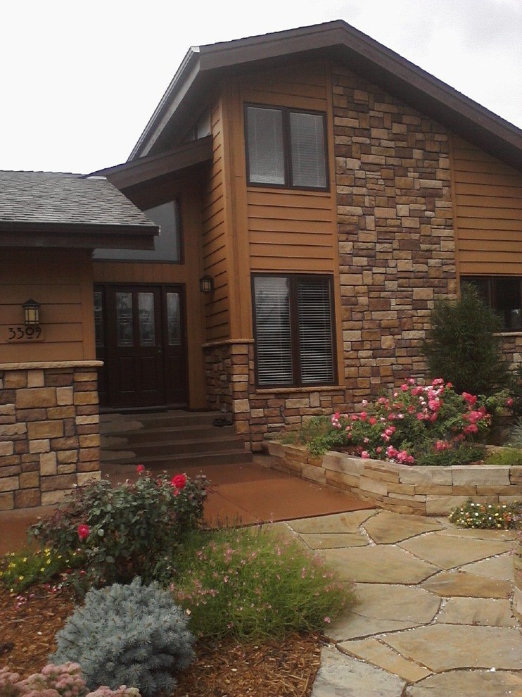 Example of a large mountain style brown two-story mixed siding exterior home design in Denver with a hip roof
