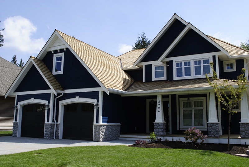 Design ideas for a large and blue traditional two floor house exterior in Vancouver with a pitched roof.