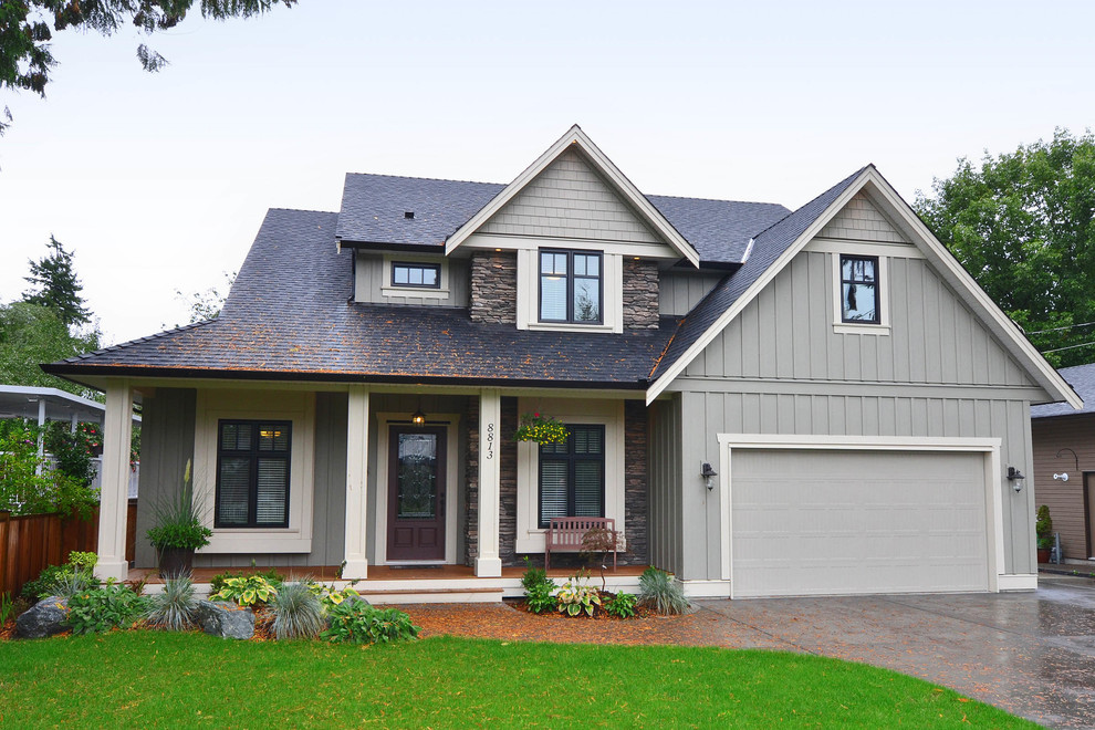 This is an example of a green traditional house exterior in Vancouver with mixed cladding, three floors and a pitched roof.