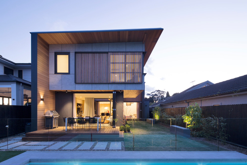 Mittelgroßes, Zweistöckiges Modernes Einfamilienhaus mit Betonfassade, Blechdach, grauer Fassadenfarbe und Pultdach in Sydney