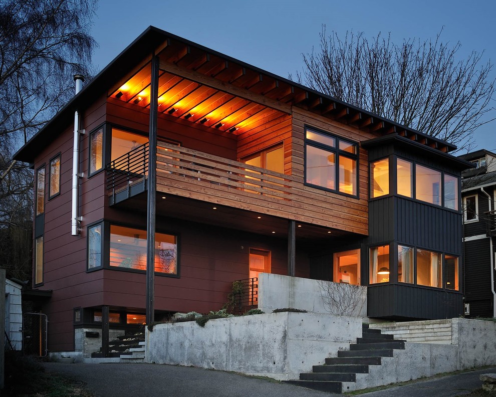 Свежая идея для дизайна: двухэтажный, красный частный загородный дом среднего размера в современном стиле с комбинированной облицовкой, односкатной крышей и металлической крышей - отличное фото интерьера