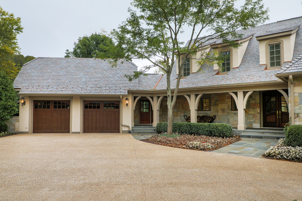 Ejemplo de fachada de casa beige clásica grande de dos plantas con revestimientos combinados, tejado de teja de madera y tejado a cuatro aguas
