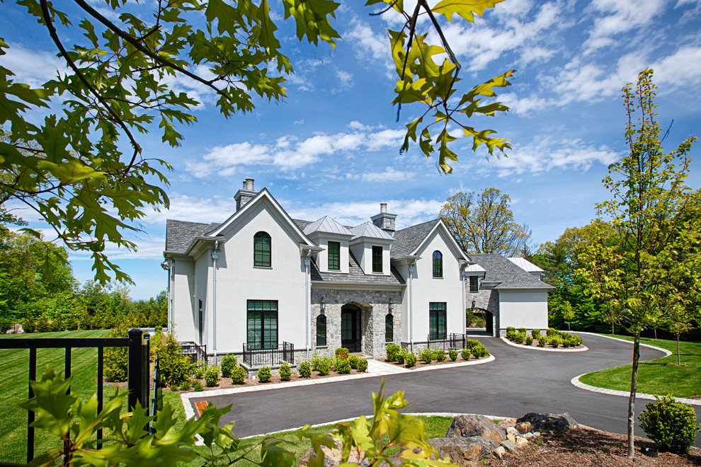 Large french country gray two-story mixed siding exterior home photo in New York with a mixed material roof