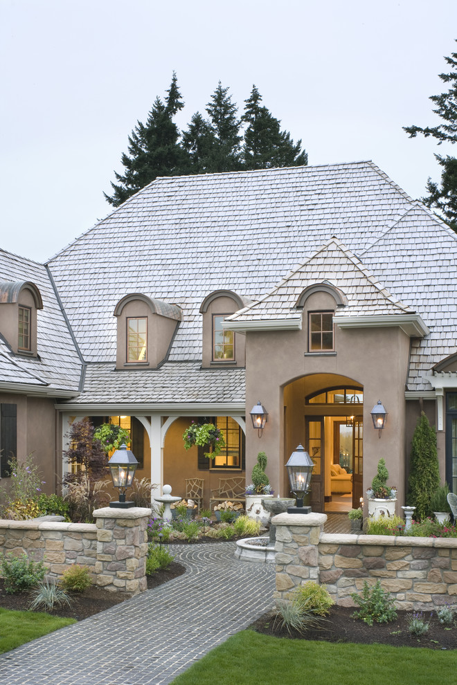 Example of a french country exterior home design in Portland