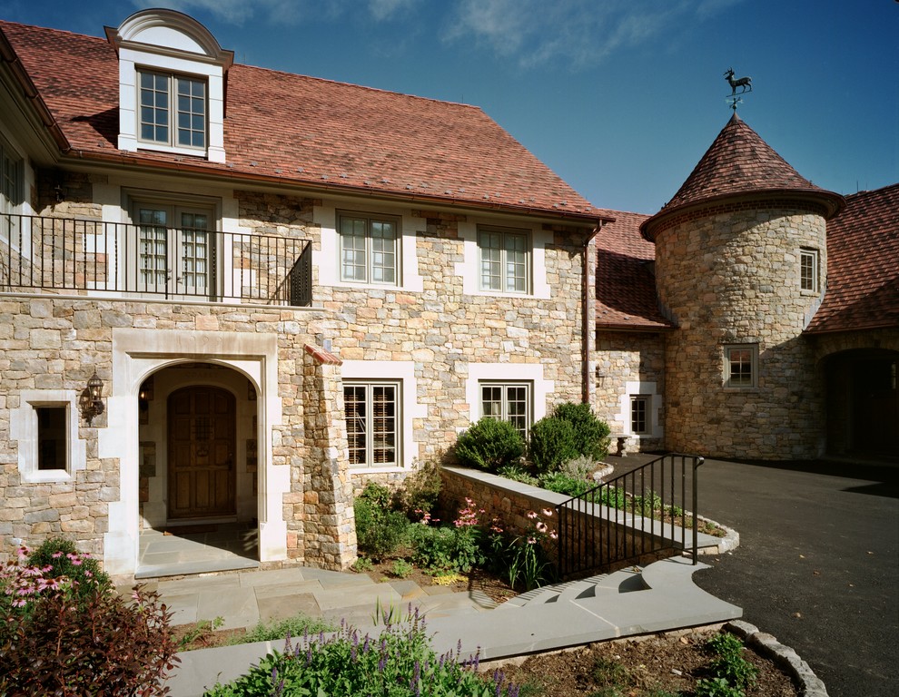 Example of a french country stone exterior home design in Philadelphia