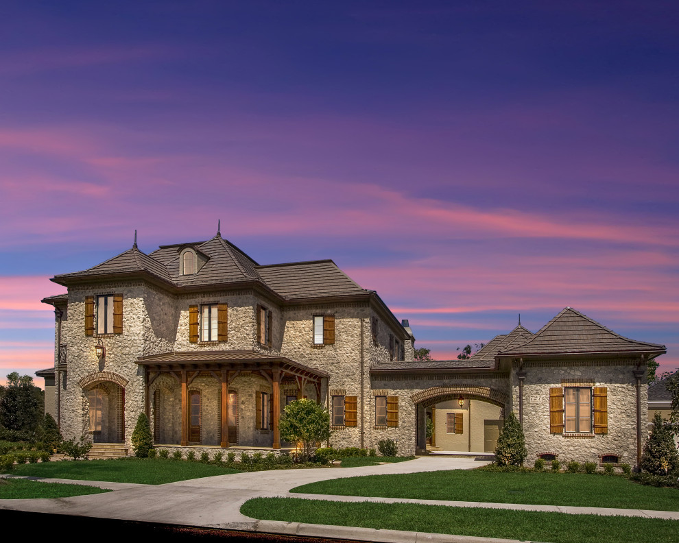 Design ideas for an expansive and beige detached house in Chicago with three floors, stone cladding and a brown roof.