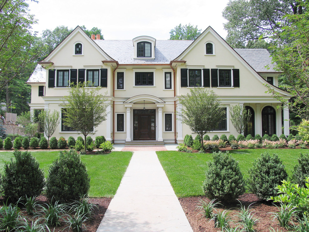 Large french country beige three-story exterior home idea in New York