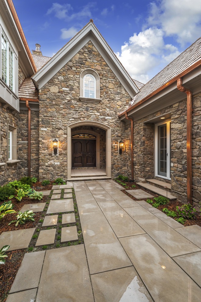 Design ideas for a classic two floor house exterior in Minneapolis with stone cladding.
