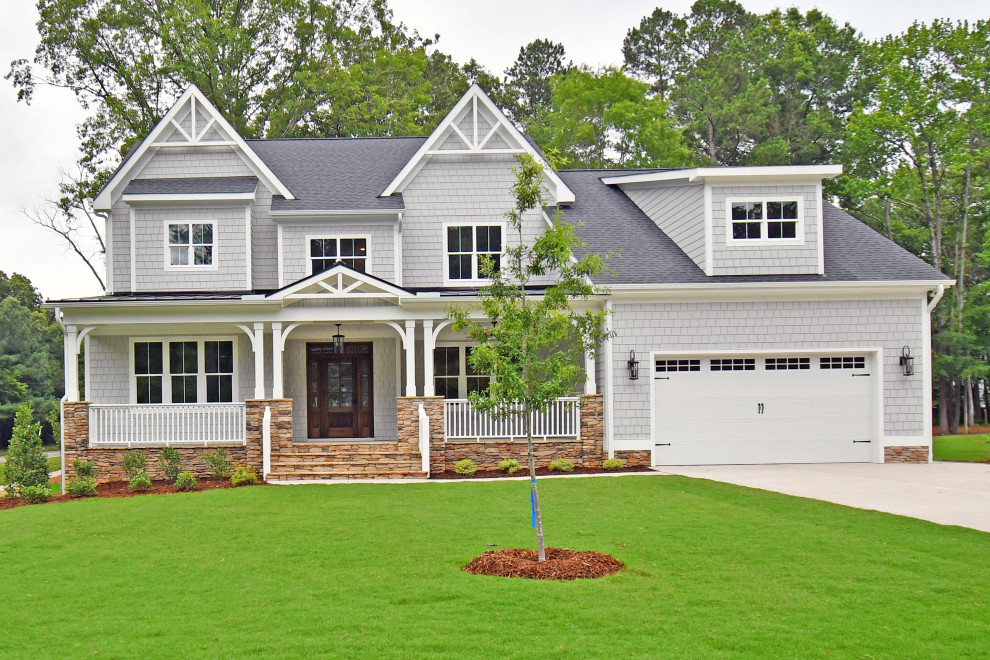 Large elegant gray two-story concrete fiberboard exterior home photo in Raleigh with a shingle roof