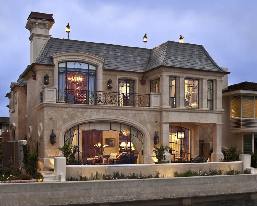 Inspiration for a large timeless beige two-story stone exterior home remodel in Orange County