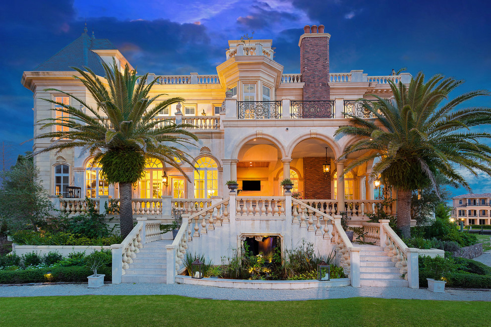 Expansive and beige mediterranean house exterior in Tampa with three floors.