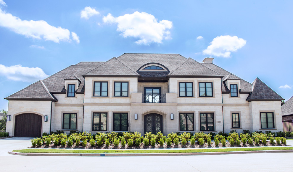 This is an example of a white and large classic two floor detached house in Dallas with stone cladding and a pitched roof.