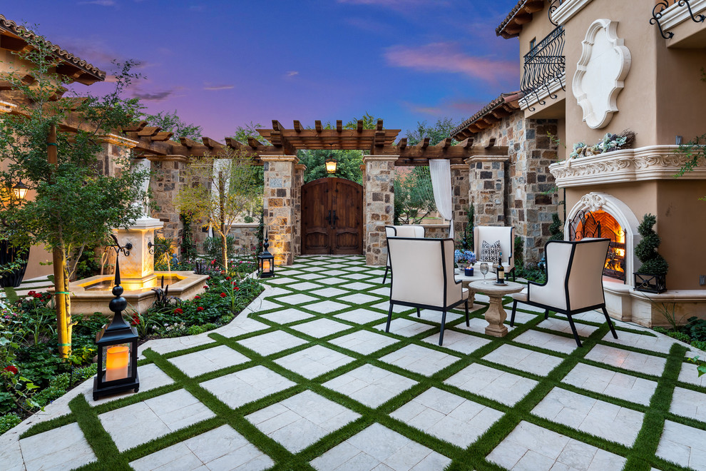 Ejemplo de patio romántico extra grande sin cubierta en patio con fuente y suelo de baldosas