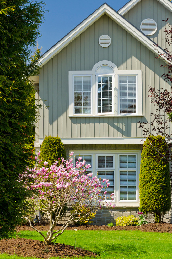 Inspiration for a mid-sized timeless gray two-story mixed siding exterior home remodel in Vancouver with a shingle roof