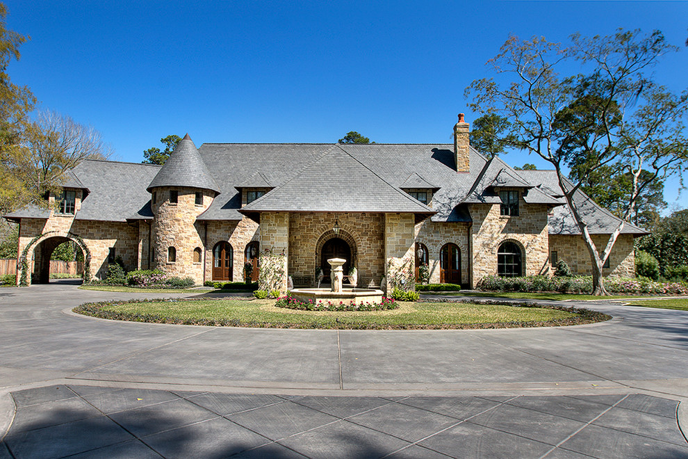 Inspiration for a classic two floor house exterior in Houston with stone cladding.