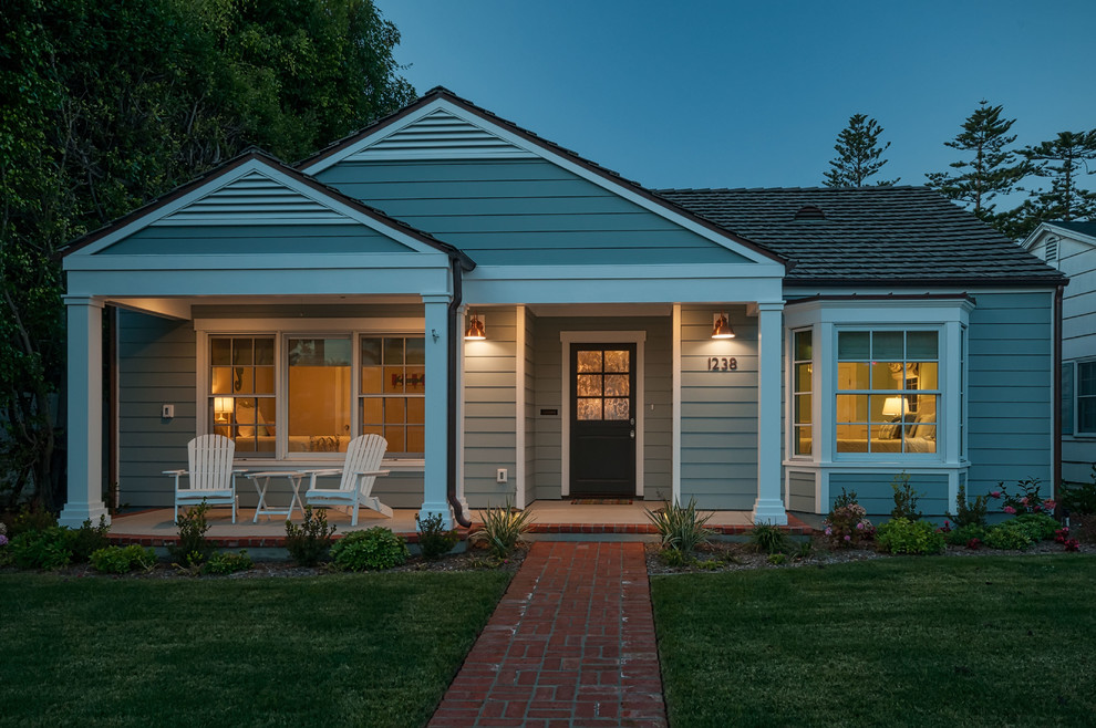 Photo of a medium sized and blue coastal bungalow house exterior in San Diego with wood cladding.