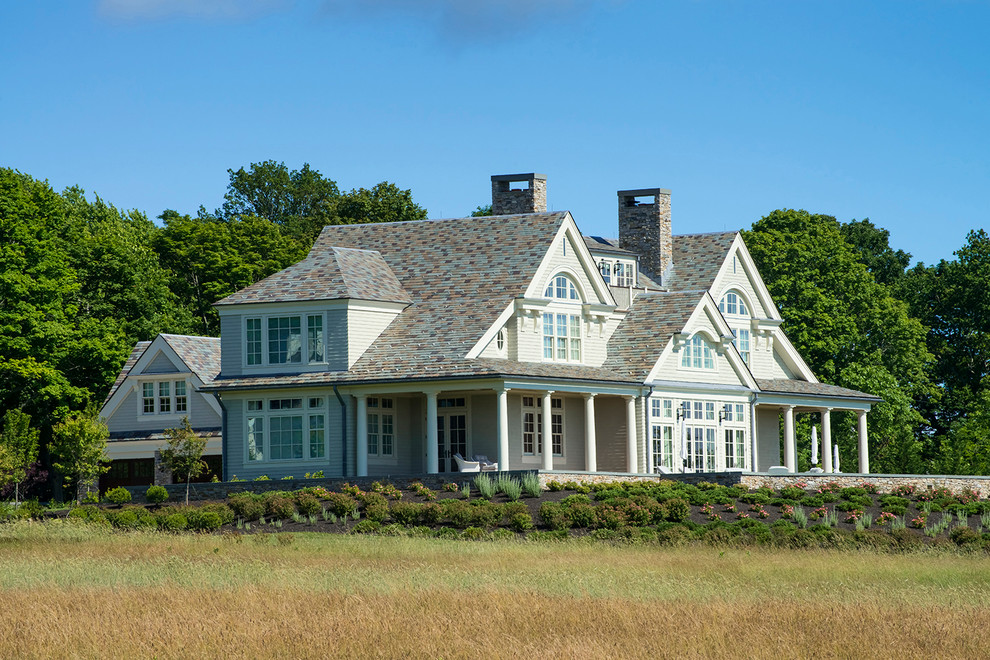 Imagen de fachada de casa gris tradicional grande de dos plantas con revestimiento de madera y tejado a dos aguas