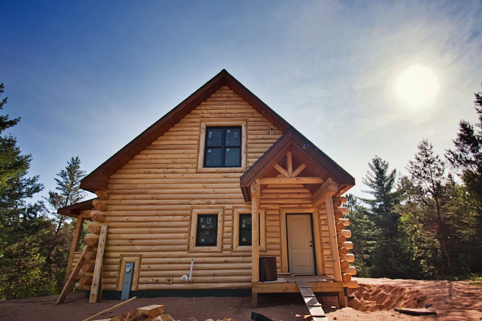 Exemple d'une façade de maison marron montagne en bois de taille moyenne et à un étage avec un toit à deux pans et un toit en shingle.