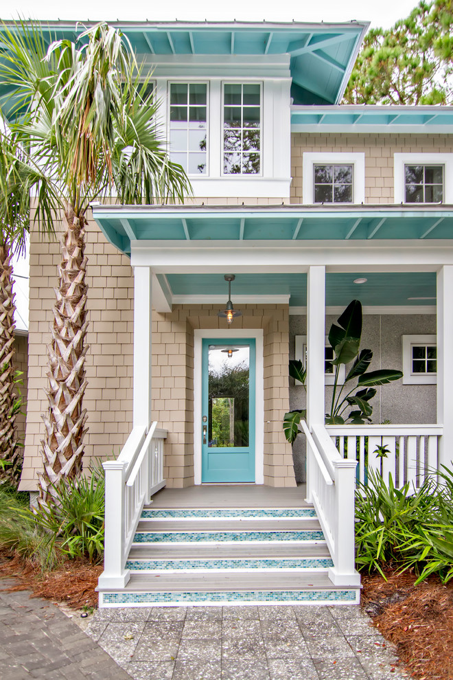 Example of a mid-sized beach style beige two-story wood house exterior design in Jacksonville with a hip roof